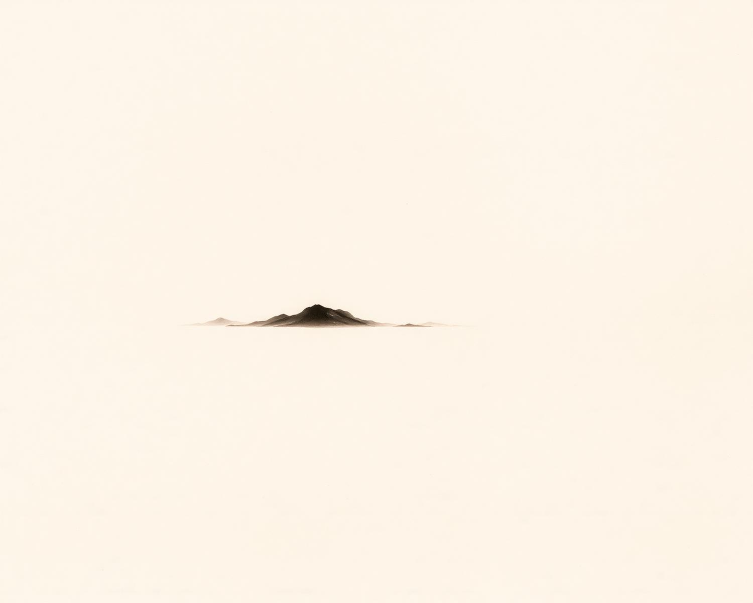 A single ink mountain rising from quiet water — an image of leaving space